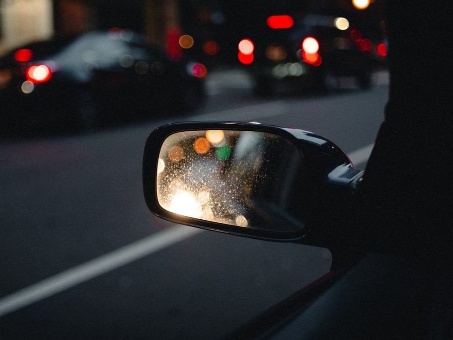 Side mirror shows traffic behind the vehicle
